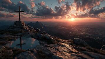 Sunset over mountain range with cross silhouette and tranquil pool photo