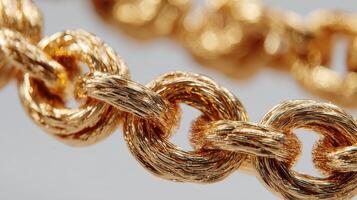Close up of elegantly crafted gold jewelry showcasing intricate chain design and texture during daylight photo