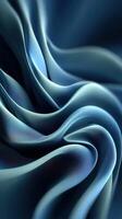 Elegant blue fabric draping gracefully to create flowing shapes and textures in soft lighting photo
