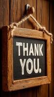 Rustic wooden sign expressing gratitude with chalkboard texture, set against a wooden door background photo
