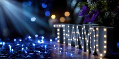 Bright thank you sign illuminated with lights and decorated with flowers at a celebration venue in the evening photo