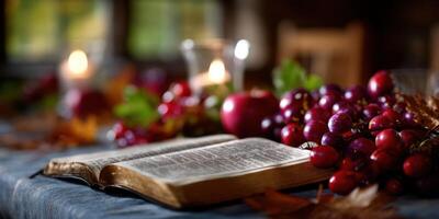 Beautiful arrangement of fruits and open book on a rustic table with candles during autumn evening photo