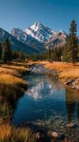 Majestic mountain peak reflects in clear stream among vibrant autumn foliage in the wilderness photo