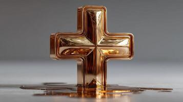 Golden cross sculpture reflecting light in a serene indoor setting during daytime photo
