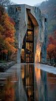 Modern climbing gym reflects autumn colors in a serene outdoor setting by a lake photo