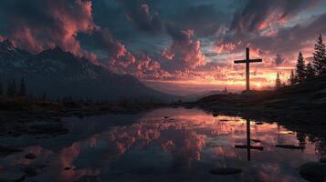 Sunset over a mountainous landscape with a cross reflected in a calm lake photo