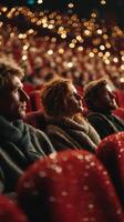 Audience enjoys a captivating performance in a theater adorned with warm lights during a night event photo