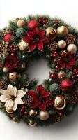 Beautiful Christmas wreath adorned with red flowers, gold ornaments, and pinecones for festive decoration photo