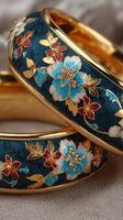 Elegant floral patterned bangles displayed on soft fabric in a warm light during a fashion showcase event photo