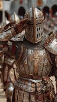 Medieval knight saluting during a historic reenactment event in a castle courtyard on a sunny afternoon photo