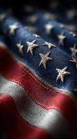 Close up view of an American flag highlighting the detailed stitching and vibrant colors of the stars and stripes photo