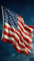 American flag waving against a clear blue sky during the afternoon photo