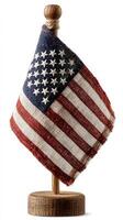 Small American flag displayed proudly on a wooden stand, symbolizing patriotism and national pride in homes or offices photo
