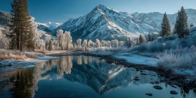 Snow-covered mountains and serene river reflect winter beauty at dawn in a tranquil valley photo