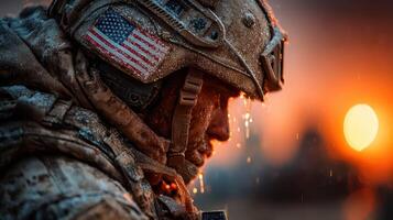 Soldier in icy environment observes sunset while water drips from helmet during military operation photo