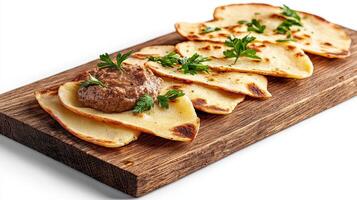 A wooden board topped with a plate of food photo