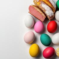 A bunch of colorful easter eggs and a loaf of bread photo