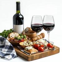 A wooden tray with two glasses of wine and food photo