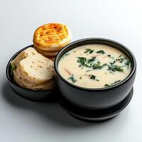 A bowl of soup with bread and biscuits photo