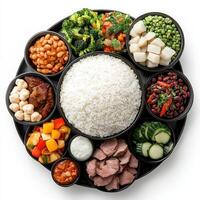 A plate with rice, beans, vegetables and meat photo