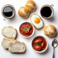 A variety of breakfast foods including bread, eggs, and tomato sauce photo