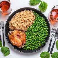 A plate of food with rice, peas, and chicken photo