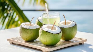 Coconut water with straws and green coconut photo