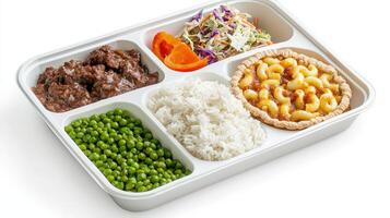 A white container with four compartments containing rice, peas, meat, and vegetables photo