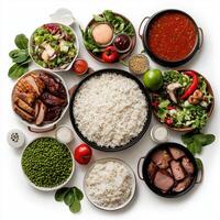 A variety of different types of food including rice, meat, vegetables and sauce photo