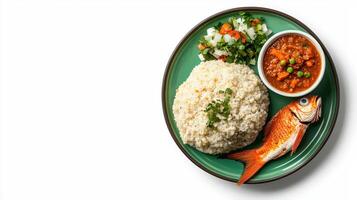 A plate with rice, fish and vegetables on it photo