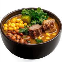A bowl of soup with meat, beans, corn and vegetables photo