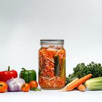 A jar of pickled vegetables and vegetables on a white background photo