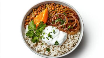 A bowl of rice, beans, and vegetables with sour cream photo