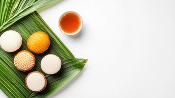 A plate of cookies and a cup of tea on a green leaf photo
