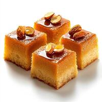 Four square cakes with nuts on top photo