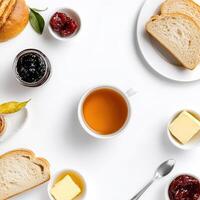 A variety of food items including bread, jam, butter and tea photo