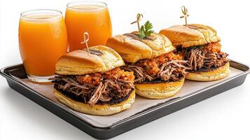 Three pulled pork sandwiches on a tray with orange juice photo