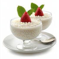 Two bowls of pudding with strawberries on top photo