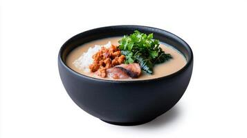 A bowl of soup with meat and vegetables in it photo