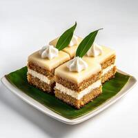 A square plate topped with four pieces of cake photo