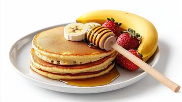 A stack of pancakes with strawberries and bananas photo