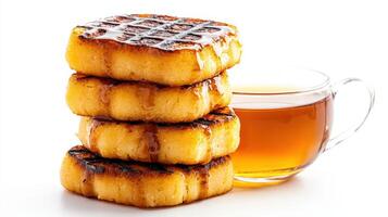 A stack of pancakes with a cup of tea photo