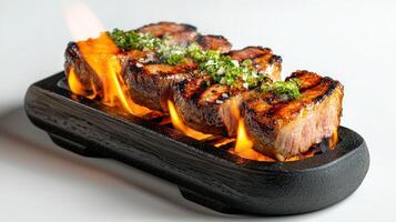 A piece of meat on a grill with fire photo