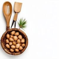 Nutty nuts in a basket with wooden utensils on a white background top view photo