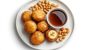 A plate with fried doughnuts and peanut butter photo