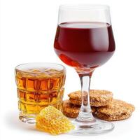 A glass of wine and cookies on a white background photo