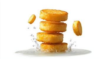 A stack of fried potatoes being tossed in water photo
