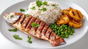 A plate with grilled fish, rice and peas photo