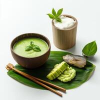 A bowl of soup with a spoon and chopsticks photo