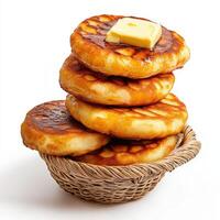 A basket with a stack of pancakes on top photo